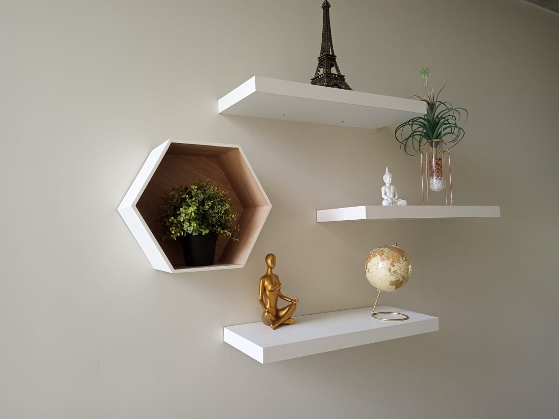 Floating shelves and a hexagonal wall shelf fitted and styled on a wall
