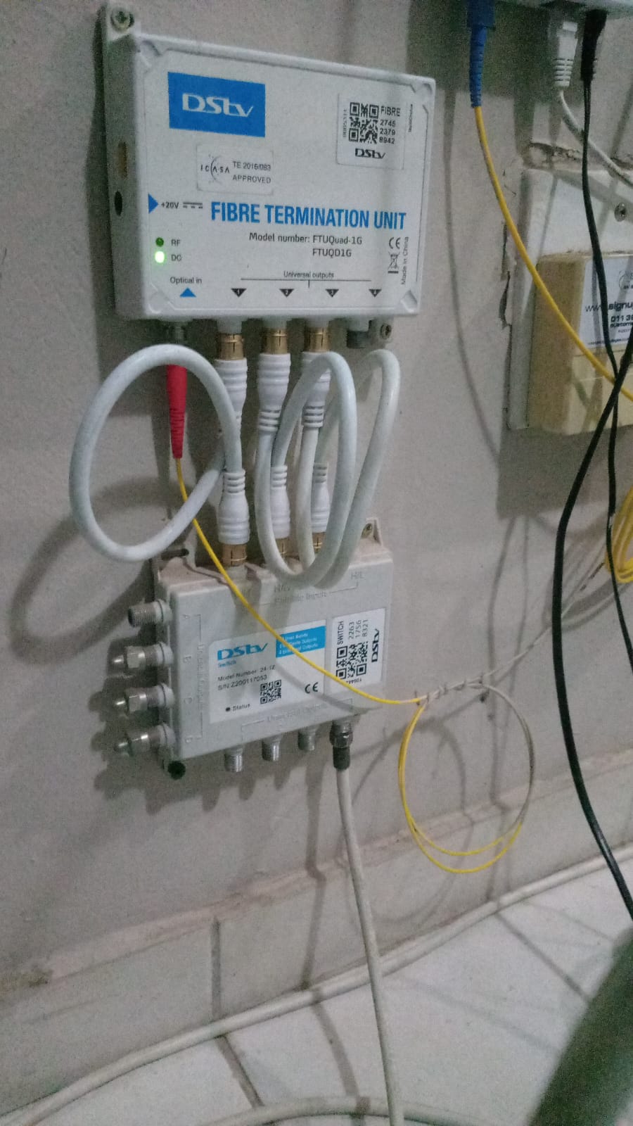 DStv fibre termination unit and multiswitch wired and labelled on a wall by TIQ Group