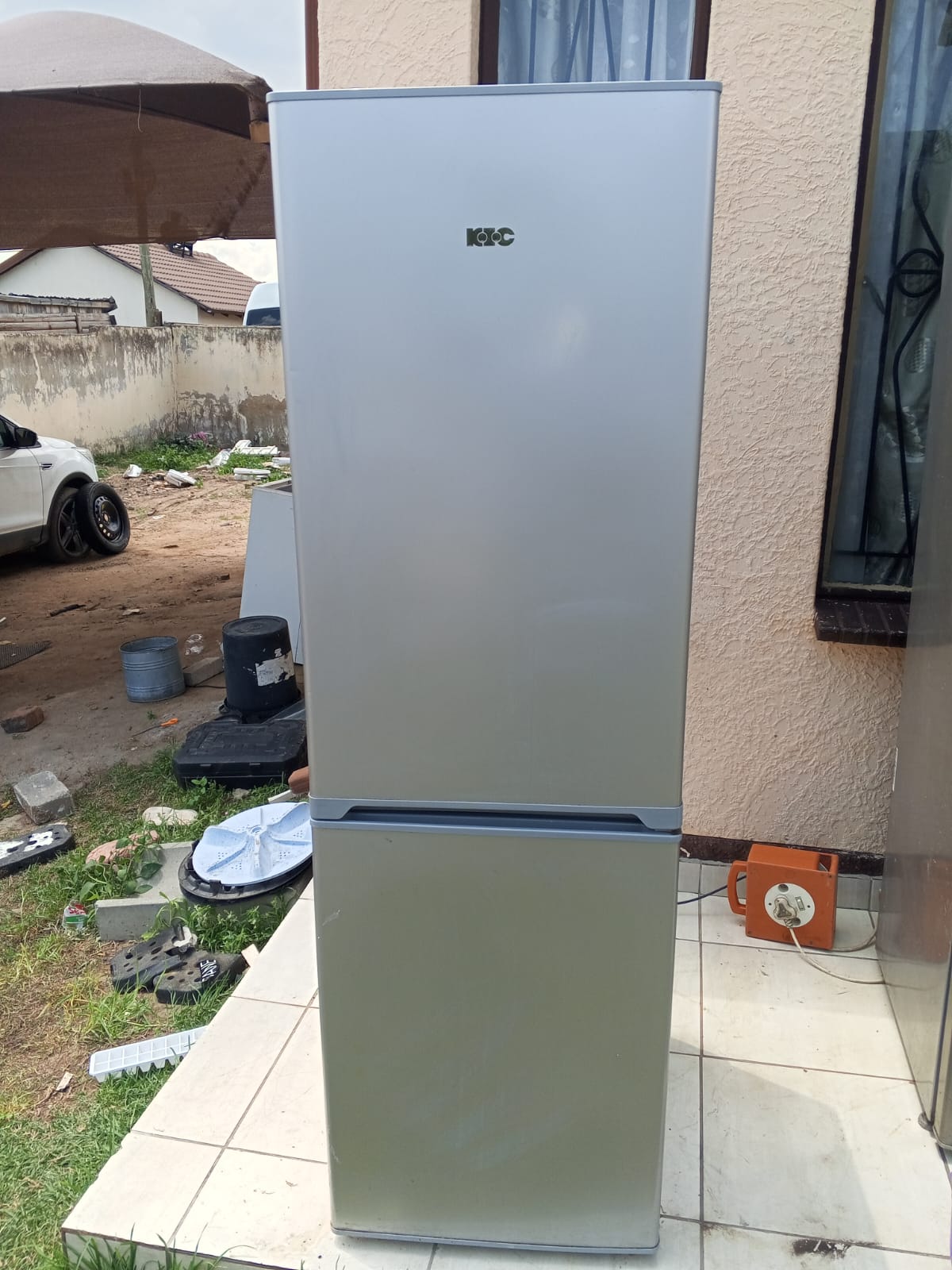 Serviced KIC fridge-freezer standing outside after a TIQ Group refrigeration repair